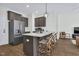 Kitchen island with white countertop and gray cabinets with seating for four people at 717 Utley St, Holly Springs, NC 27540