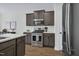 Kitchen featuring stainless steel appliances, gray cabinets, and white countertops at 717 Utley St, Holly Springs, NC 27540