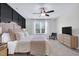 Serene main bedroom with a ceiling fan and natural light, offering a peaceful retreat at 717 Utley St, Holly Springs, NC 27540