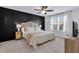 Bedroom with a king bed, dark accent wall, and large window with natural light at 717 Utley St, Holly Springs, NC 27540