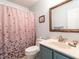 Charming bathroom with vanity, updated sink, and a decorative shower curtain at 7312 Sweet Bay Ln, Raleigh, NC 27615