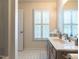 Bright bathroom featuring a window with shutters and a vanity sink at 7312 Sweet Bay Ln, Raleigh, NC 27615