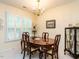 Formal dining room with a chandelier and large windows with shutters offering natural light at 7312 Sweet Bay Ln, Raleigh, NC 27615