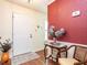 Entryway featuring hardwood floors, decorative wallpaper, and elegant furnishings at 7312 Sweet Bay Ln, Raleigh, NC 27615