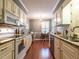 Well-lit kitchen with granite countertops, stainless steel appliances, and a breakfast nook area at 7312 Sweet Bay Ln, Raleigh, NC 27615