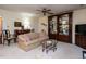 Cozy living room with classic furnishings, a ceiling fan, and a built-in display cabinet at 7312 Sweet Bay Ln, Raleigh, NC 27615