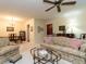 Bright living room featuring comfortable seating, ceiling fan, and an adjoining dining area at 7312 Sweet Bay Ln, Raleigh, NC 27615