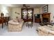 Comfortable living room featuring classic decor, a ceiling fan, fireplace and built-in display cabinet at 7312 Sweet Bay Ln, Raleigh, NC 27615