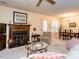 Inviting living room with fireplace, ceiling fan, and comfortable seating arrangements at 7312 Sweet Bay Ln, Raleigh, NC 27615