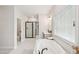 Bathroom showcasing tub, shower, and modern vanity with natural light at 772 Mirkwood Ave, Apex, NC 27523