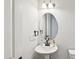 Elegant bathroom with a pedestal sink and stylish fixtures at 772 Mirkwood Ave, Apex, NC 27523