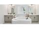 Bright bathroom with dual sinks, soaking tub, and modern fixtures at 772 Mirkwood Ave, Apex, NC 27523