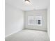 Neutral bedroom features natural light from dual windows and plush carpet for comfort at 772 Mirkwood Ave, Apex, NC 27523