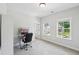 Bright bedroom features neutral walls, carpet, natural light, and a workstation for work or studying at 772 Mirkwood Ave, Apex, NC 27523