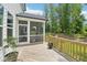 Inviting screened-in porch extends from the wood deck with views of the backyard and wood line at 772 Mirkwood Ave, Apex, NC 27523