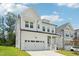 Attractive modern farmhouse with a two-car garage, green lawn, and covered front porch at 772 Mirkwood Ave, Apex, NC 27523