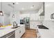 Modern kitchen with white cabinets, stainless steel appliances, and a large island at 772 Mirkwood Ave, Apex, NC 27523