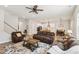 Open concept living area with hardwood floors, access to the kitchen, and stairwell at 772 Mirkwood Ave, Apex, NC 27523