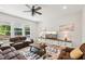 Spacious living room featuring hardwood floors, a ceiling fan, and lots of seating at 772 Mirkwood Ave, Apex, NC 27523