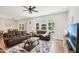 Inviting living room with hardwood floors, a ceiling fan, and a view of the kitchen at 772 Mirkwood Ave, Apex, NC 27523