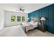 Spacious main bedroom with a statement wall, large windows, and plush carpet at 772 Mirkwood Ave, Apex, NC 27523