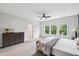 Light-filled main bedroom with a wooden dresser and large windows at 772 Mirkwood Ave, Apex, NC 27523