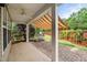 This covered back patio has a brick floor, with an awning and a view of the manicured backyard at 7873 Cape Charles Dr, Raleigh, NC 27617