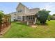 Well-maintained backyard featuring a paver patio, lawn, and mature landscaping at 7873 Cape Charles Dr, Raleigh, NC 27617