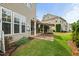 A home's backyard shows an awning-covered patio and beautiful green lawn at 7873 Cape Charles Dr, Raleigh, NC 27617