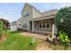 Charming home showcases an awning-covered patio and beautifully maintained lawn at 7873 Cape Charles Dr, Raleigh, NC 27617