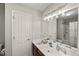 This sleek bathroom has a vanity with a stylish sink, modern fixtures, and a large, framed mirror at 7873 Cape Charles Dr, Raleigh, NC 27617