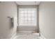 Bright bathroom featuring a jetted tub under a window, and a towel bar at 7873 Cape Charles Dr, Raleigh, NC 27617