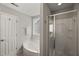 Bright bathroom featuring a white shower stall and jetted tub near a window at 7873 Cape Charles Dr, Raleigh, NC 27617