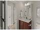 Cozy bathroom with a cherry vanity, matching mirror and decor accents at 7873 Cape Charles Dr, Raleigh, NC 27617