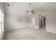Bright, carpeted primary bedroom with doorway to ensuite bath and ceiling fan at 7873 Cape Charles Dr, Raleigh, NC 27617