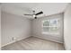 This light-filled bedroom features neutral walls, carpet floors, and a ceiling fan for added comfort at 7873 Cape Charles Dr, Raleigh, NC 27617