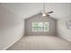 Bright, carpeted bedroom with three windows and a vaulted ceiling featuring a ceiling fan at 7873 Cape Charles Dr, Raleigh, NC 27617
