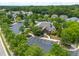 Aerial view of the community pool, clubhouse, parking and surrounding neighborhood at 7873 Cape Charles Dr, Raleigh, NC 27617