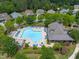 Aerial view of the sparkling community pool with ample lounge chairs and umbrellas at 7873 Cape Charles Dr, Raleigh, NC 27617