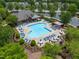 An aerial shows the resort-style pool with pergolas and grilling area in this neighborhood at 7873 Cape Charles Dr, Raleigh, NC 27617