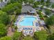 An aerial shows the resort-style pool with pergolas and grilling area in this neighborhood at 7873 Cape Charles Dr, Raleigh, NC 27617