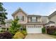Traditional two-story home with a large garage and well-manicured landscaping at 7873 Cape Charles Dr, Raleigh, NC 27617