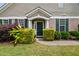 Charming front entrance with a green door and colorful, well-maintained landscaping at 7873 Cape Charles Dr, Raleigh, NC 27617