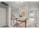 This upper hallway area has an archway, and a view into a carpeted room with a ceiling fan at 7873 Cape Charles Dr, Raleigh, NC 27617