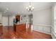Open-concept kitchen featuring a center island, hardwood floors, and an archway leading to the living room at 7873 Cape Charles Dr, Raleigh, NC 27617