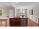 Kitchen island with double sink and dishwasher, with dining room in the background at 7873 Cape Charles Dr, Raleigh, NC 27617