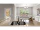 Bright kitchen featuring a stainless steel sink, granite countertops, and white trim accents at 7873 Cape Charles Dr, Raleigh, NC 27617