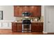 Updated kitchen featuring stainless steel appliances and warm wood cabinetry at 7873 Cape Charles Dr, Raleigh, NC 27617