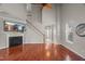 Spacious living room with hardwood floors, fireplace, staircase, and views of the entryway and dining area at 7873 Cape Charles Dr, Raleigh, NC 27617