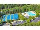 A top-down perspective of the community's tennis and pool areas, surrounded by dense trees at 804 Town Side Dr, Apex, NC 27502